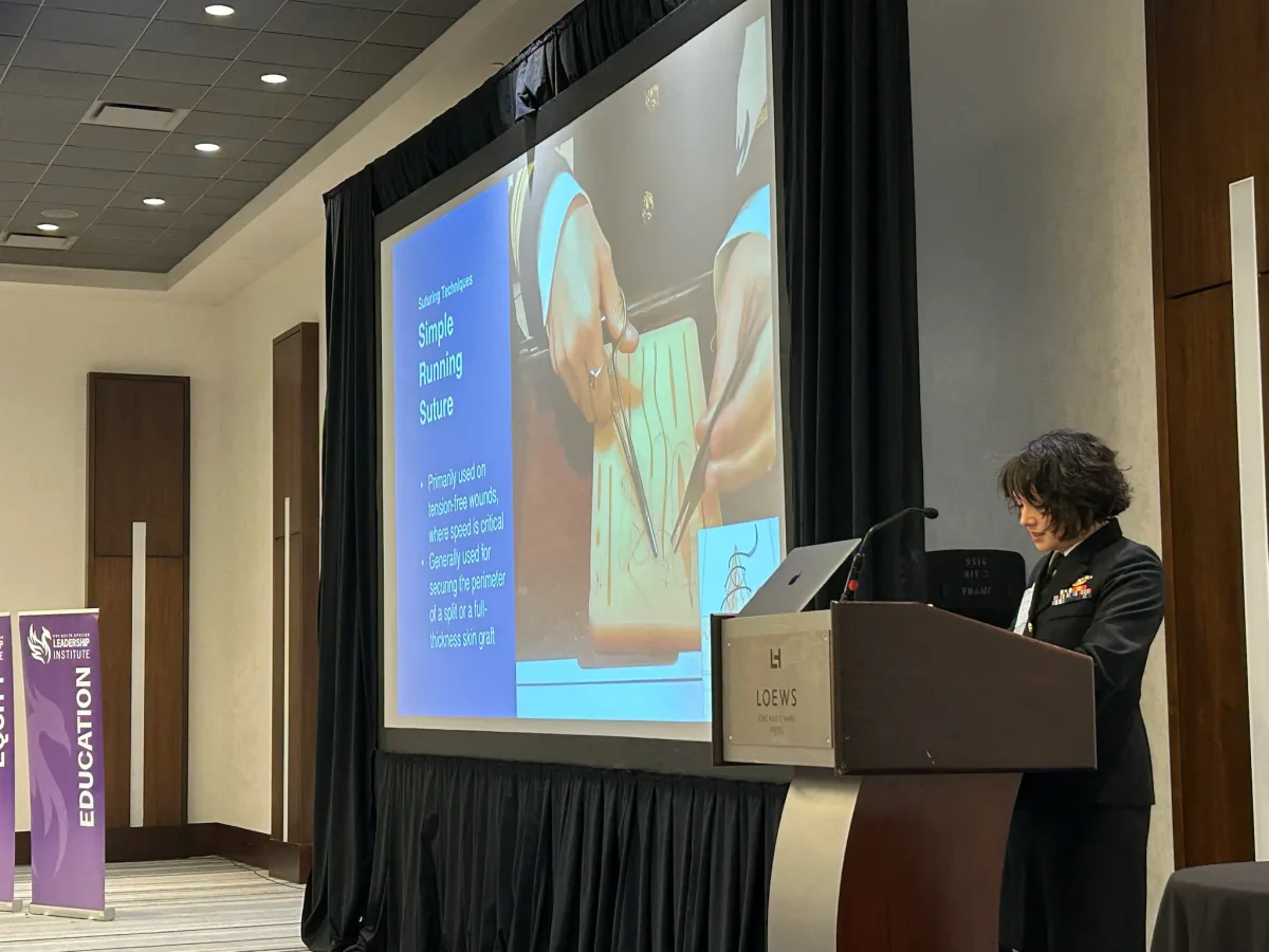 Dr. Brahe lecturing on suture and closure techniques at a national conference