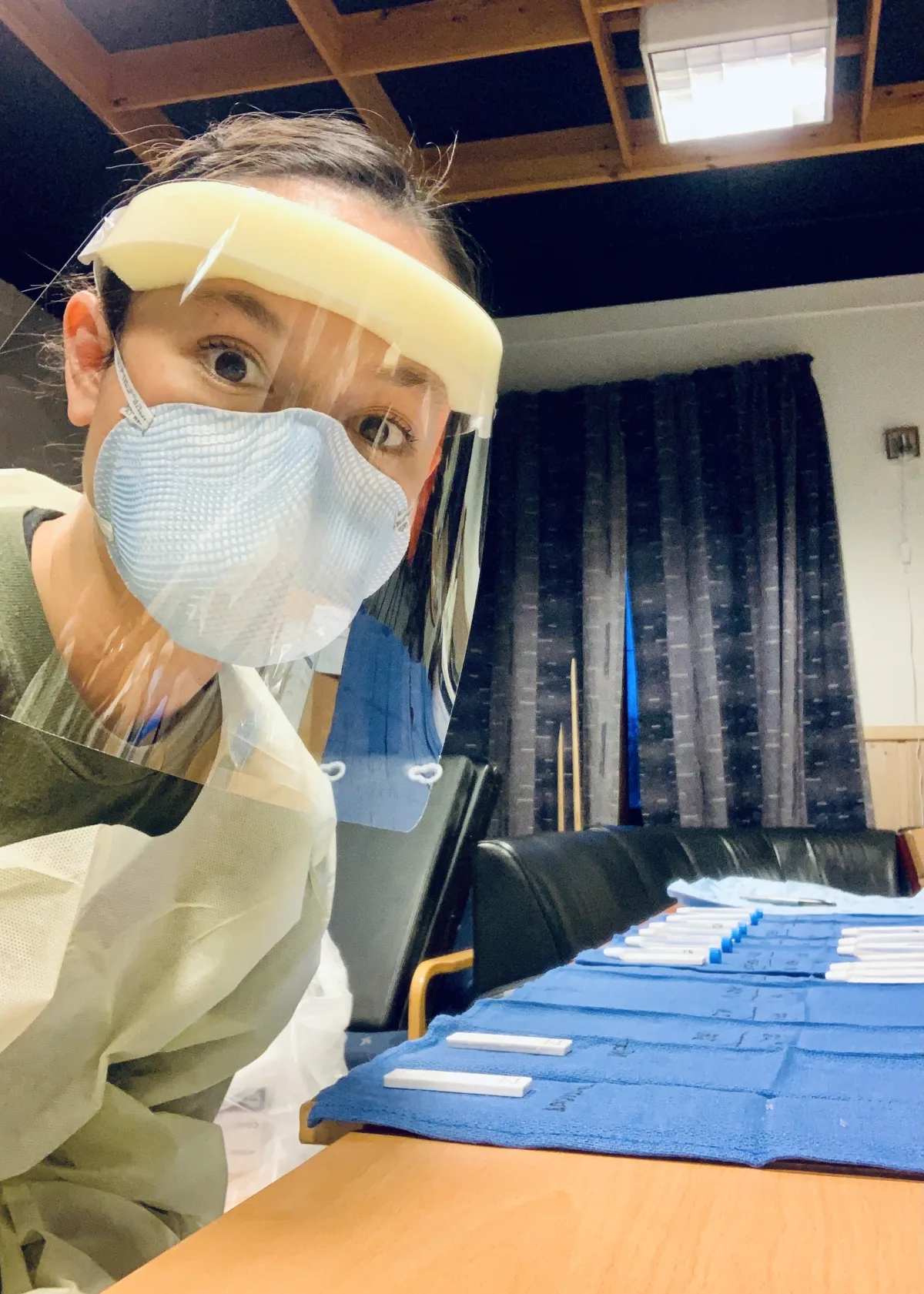 Dr. Brahe in PPE preparing medical kits during deployment