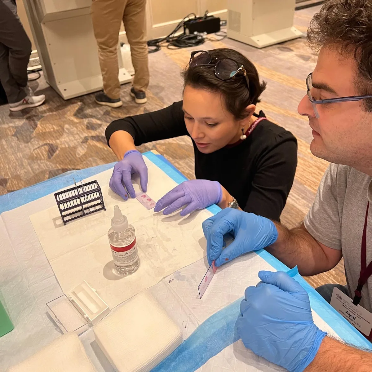 Dr. Brahe preparing histopathology slides for dermatopathology examination