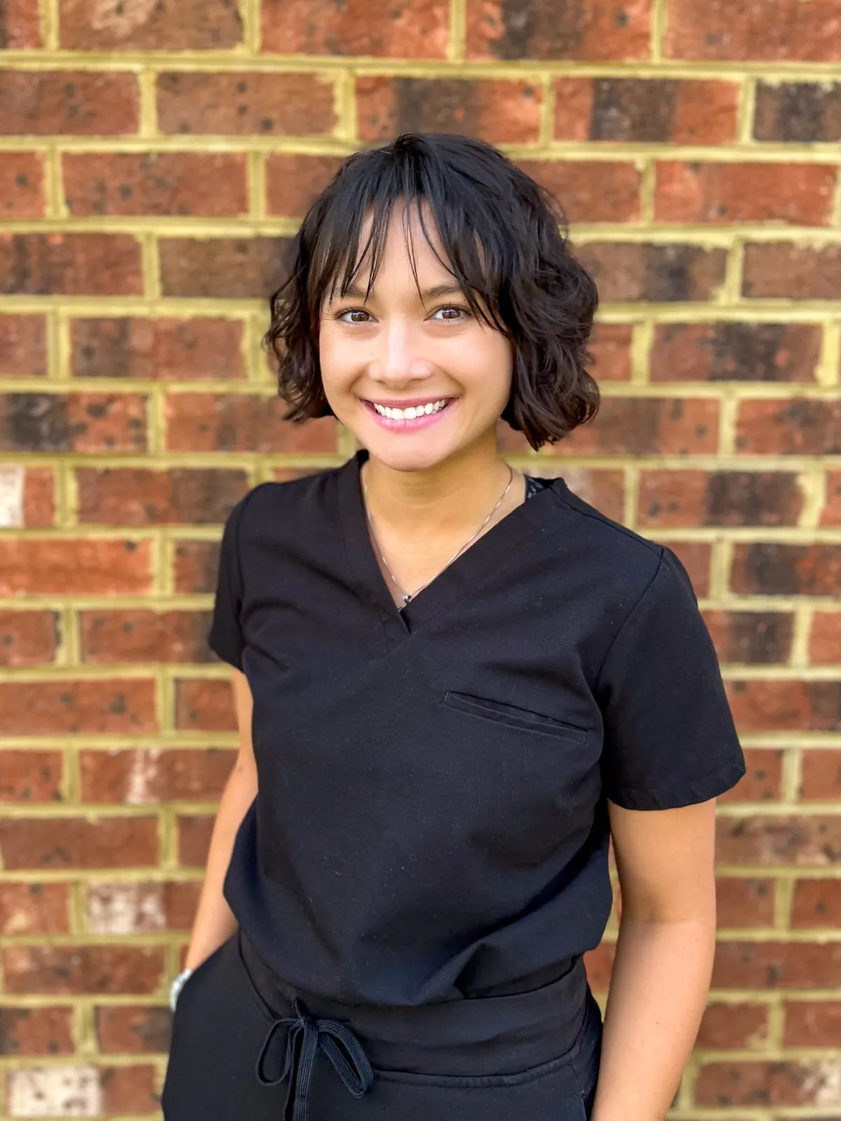 Dr. Catherine Brahe in clinical scrubs